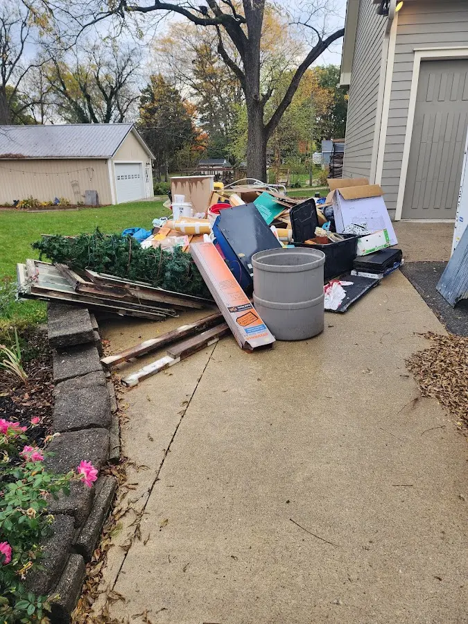 Dumpster being loaded with debris for Estate Cleanout Dumpster Rental in Atchison